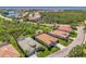 Wide aerial shot displays well-kept homes in residential neighborhood near a beautiful blue lake at 13217 Scrub Jay Ct, Port Charlotte, FL 33953
