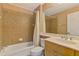 Cozy bathroom with a tub and shower combo, and a light wood vanity with a large mirror at 13217 Scrub Jay Ct, Port Charlotte, FL 33953