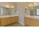 Spacious bathroom with dual vanities, large mirrors, and tiled floors at 13217 Scrub Jay Ct, Port Charlotte, FL 33953
