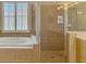 Bathroom featuring a walk-in shower, soaking tub, and tile surround at 13217 Scrub Jay Ct, Port Charlotte, FL 33953