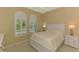 Inviting bedroom with plantation shutters, carpeted floor, and ample natural light at 13217 Scrub Jay Ct, Port Charlotte, FL 33953