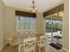 Cozy dining area with views of the pool and patio, perfect for entertaining guests at 13217 Scrub Jay Ct, Port Charlotte, FL 33953