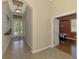 Inviting foyer with tile flooring leads to a bedroom and front door that provides lots of light at 13217 Scrub Jay Ct, Port Charlotte, FL 33953
