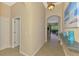 Welcoming foyer with neutral walls, archways, and tile flooring leading into the main living space at 13217 Scrub Jay Ct, Port Charlotte, FL 33953
