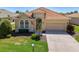 Charming single-story home featuring a red tile roof, manicured lawn, and a two-car garage at 13217 Scrub Jay Ct, Port Charlotte, FL 33953
