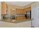 Stylish kitchen with granite counters, mosaic backsplash, stainless appliances, and open layout at 13217 Scrub Jay Ct, Port Charlotte, FL 33953