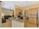 Modern kitchen with granite counters, stainless appliances, mosaic backsplash, and open to living area at 13217 Scrub Jay Ct, Port Charlotte, FL 33953