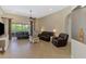 Spacious living room with tile floors, ceiling fan, and a view of the screened-in lanai at 13217 Scrub Jay Ct, Port Charlotte, FL 33953