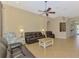 Cozy living room with neutral colors, tile flooring, ceiling fan, and comfortable seating at 13217 Scrub Jay Ct, Port Charlotte, FL 33953