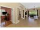Open-concept living room featuring tile flooring, columns, and ample natural light at 13217 Scrub Jay Ct, Port Charlotte, FL 33953