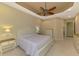 Bright main bedroom features a tray ceiling, neutral colors, and carpeted floors at 13217 Scrub Jay Ct, Port Charlotte, FL 33953