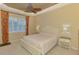 Serene main bedroom with tray ceiling, carpeted floors, and a large window for natural light at 13217 Scrub Jay Ct, Port Charlotte, FL 33953