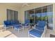 Relax on this covered patio with comfortable blue seating and beautiful views at 13217 Scrub Jay Ct, Port Charlotte, FL 33953