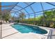 The sparkling pool is surrounded by a screen enclosure for added privacy and relaxation at 13217 Scrub Jay Ct, Port Charlotte, FL 33953