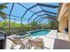 The outdoor living space includes a spa, a pool, and lounge chairs for ultimate relaxation at 13217 Scrub Jay Ct, Port Charlotte, FL 33953