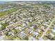 A stunning aerial view showcasing a tranquil neighborhood, with neatly arranged houses and picturesque natural surroundings at 1365 Sussex Rd, Venice, FL 34293