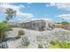 Spacious backyard featuring low-maintenance gravel landscaping and a screened lanai for outdoor relaxation at 1365 Sussex Rd, Venice, FL 34293