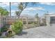 Fenced backyard with a stone pathway and low-maintenance landscaping, offering privacy and charm at 1365 Sussex Rd, Venice, FL 34293