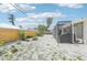 Low-maintenance backyard with a gravel landscape, a wooden fence, and a comfortable outdoor seating area at 1365 Sussex Rd, Venice, FL 34293