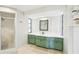 Bathroom featuring a glass-enclosed shower, green cabinetry, and sleek countertops at 1365 Sussex Rd, Venice, FL 34293