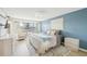 Cozy bedroom featuring a serene blue accent wall and a sliding glass door with outdoor views at 1365 Sussex Rd, Venice, FL 34293