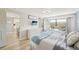 Sunlit bedroom with a view to the kitchen, featuring a cozy seating area and neutral decor at 1365 Sussex Rd, Venice, FL 34293