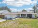 Charming single-story home boasting a well-manicured lawn, stone accents, and an attached garage at 1365 Sussex Rd, Venice, FL 34293