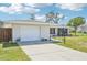 Charming single-story home featuring a well-maintained lawn, attached garage, and inviting curb appeal at 1365 Sussex Rd, Venice, FL 34293