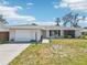 Charming single-story home boasting a well-manicured lawn, stone accents, and an attached garage at 1365 Sussex Rd, Venice, FL 34293