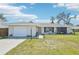 Charming single-story home with a well-manicured lawn, attached garage, and lovely curb appeal at 1365 Sussex Rd, Venice, FL 34293