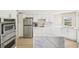 Well-equipped kitchen with stainless steel appliances and a stylish marble island at 1365 Sussex Rd, Venice, FL 34293