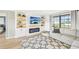 Bright living room with a modern fireplace, stylish built-ins, and a large window at 1365 Sussex Rd, Venice, FL 34293