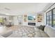 Open concept living area featuring built-in shelving, an electric fireplace, and a view of the dining area at 1365 Sussex Rd, Venice, FL 34293
