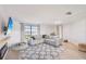 Spacious living room with a comfortable sofa, stylish rug, and ample natural light at 1365 Sussex Rd, Venice, FL 34293