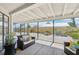 Cozy screened patio with comfortable seating and view of the serene, low-maintenance backyard at 1365 Sussex Rd, Venice, FL 34293