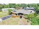Aerial view of a well-maintained single Gathering home with lush landscaping and an attached garage at 1386 Dewitt St, Port Charlotte, FL 33952
