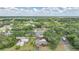 Scenic aerial view of a single-story house, neighborhood, and lush green landscape under a blue sky at 1386 Dewitt St, Port Charlotte, FL 33952