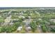 Expansive aerial view of a neighborhood with lush greenery, houses, and a serene waterway at 1386 Dewitt St, Port Charlotte, FL 33952