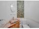 Unique powder room with decorative tile accents, custom sink and vanity at 1386 Dewitt St, Port Charlotte, FL 33952