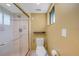 Modern bathroom features a glass enclosed shower and white toilet with a sleek design at 1386 Dewitt St, Port Charlotte, FL 33952