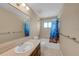Bathroom with a sink with vanity, mirror and shower featuring a brightly colored shower curtain at 1386 Dewitt St, Port Charlotte, FL 33952