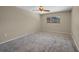 Bright, airy bedroom featuring plush carpeting, a ceiling fan, and a large window at 1386 Dewitt St, Port Charlotte, FL 33952