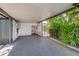 Carport with plenty of storage space and a peek at the pool area at 1386 Dewitt St, Port Charlotte, FL 33952