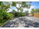 A home exterior with a covered parking area, lush tropical landscaping, and a peek at the pool at 1386 Dewitt St, Port Charlotte, FL 33952