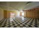Garage with checkered flooring, fan, wall decor, and adjacent doorways for flexible use at 1386 Dewitt St, Port Charlotte, FL 33952