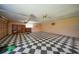 Garage featuring a checkerboard floor, built in shelving, and plenty of space at 1386 Dewitt St, Port Charlotte, FL 33952