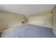 Open-concept living room featuring tile and carpeted floors with a view into the kitchen at 1386 Dewitt St, Port Charlotte, FL 33952