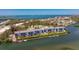 Breathtaking aerial view of waterfront condos, docks, and lush surroundings with ocean in the distance at 1401 S Mccall Rd # A 108, Englewood, FL 34223