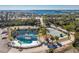 Aerial view of the community amenities: tennis court, pool, pond, and condo buildings with water views at 1401 S Mccall Rd # A 108, Englewood, FL 34223