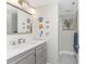 Updated bathroom with gray vanity, marble countertop and framed mirror with unique decorations at 1401 S Mccall Rd # A 108, Englewood, FL 34223